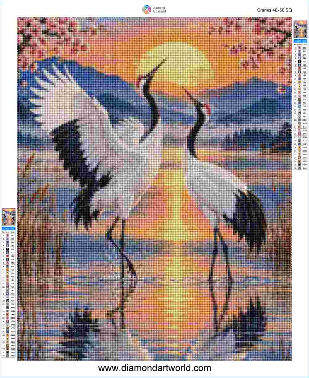 A diamond painting artwork featuring two white cranes with black wings standing in shallow water at sunset, with pink blossoms, mountains, and a glowing sun in the background. The image includes a brand header at the top and color swatch bars on the sides. Cranes - Diamond Painting