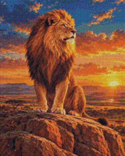 A lion with a golden-brown mane sits on a rocky outcrop against a dramatic sunset sky filled with orange, yellow, and blue clouds. Lion King - Diamond Painting