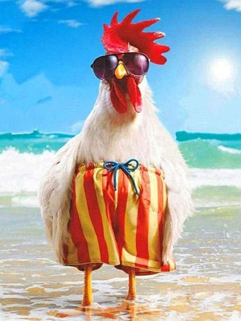 A white chicken standing on a sandy beach wearing red and yellow striped swim trunks with a blue bow and dark sunglasses, with ocean waves and a bright blue sky in the background. Holiday Rooster Diamond Painting