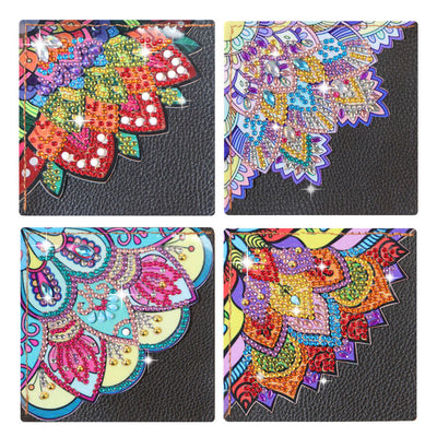 Four square decorative diamond art bookmarks arranged in a 2x2 grid on a black textured background. Each item features a colorful mandala or floral pattern with rhinestone-like embellishments in pink, blue, yellow, green, orange, and purple.